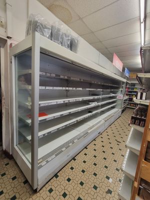 many empty shelves in a store that are full of items