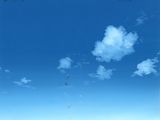 many kites flying in the blue sky above the beach