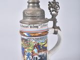 a beer mug with a picture on it sitting on a table