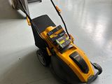 the yellow and black lawn mower is sitting on the floor in the room