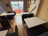 tables and chairs in a small room with a sliding glass door