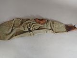 a wooden dummy of a soldier laying on a white surface