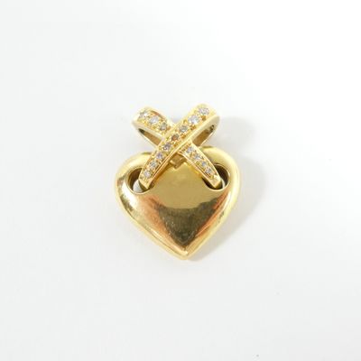 a close up of a heart shaped brooch with a cross on it