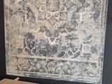 an image of a large rug hanging on a wall in a room