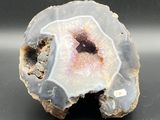 a picture of a piece of rock with a pink center