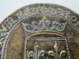 a close up of a coin with a crown on it