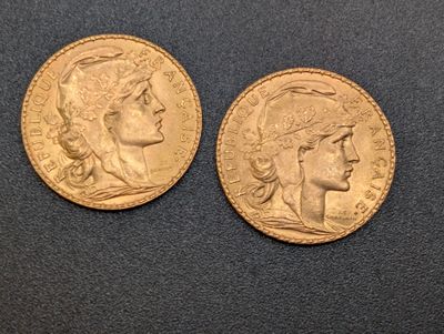 two gold sovereigns, one of which is a woman and one of which is a man