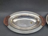a silver plate and a silver bowl on a table