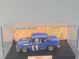 a blue toy car in a display case on a table