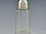 a small glass salt shaker with a silver top