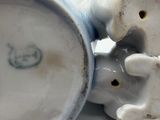 a close up of a ceramic figurine of a dog and a cat
