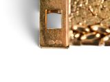 a close up picture of a gold bracelet with a chain