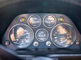 a close up of a car dashboard with various gauges