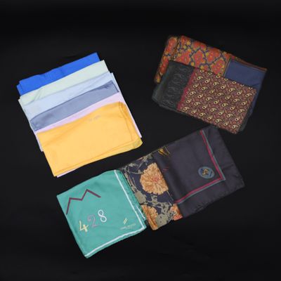several different colored handkerchiefs laid out on a black surface