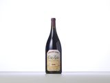 a bottle of red wine sitting on top of a table