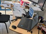 a desk with a laptop and a laptop computer on it