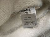 chanel label on a white sweater in a store