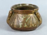 an image of a bronze vase on a white surface