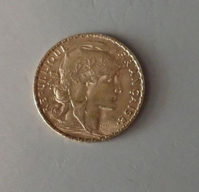 a close up of a gold coin with a woman ' s face on it