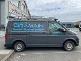 a van parked in front of a building with a sign on the side of it