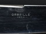 a close up of a knife on a black surface