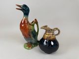 two vases with birds on them sitting next to each other
