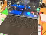 a laptop computer sitting on a desk in front of a computer monitor