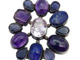 a close up of a purple and blue stone broochle