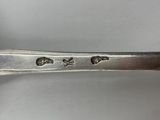 a close up of a spoon on a white surface