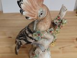a figurine of a bird sitting on a table