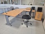 a desk with a chair and a computer on it