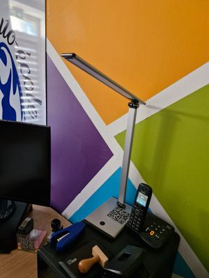 a desk with a laptop and a phone on it