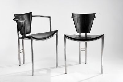 pair of black and chrome chairs against a white backdrop
