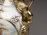 a white and gold vase with a painting on it