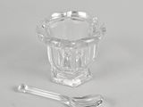 side view of a glass bowl and a spoon showing the inside of the bowl