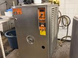 a machine that is sitting in a kitchen next to a sink