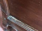 a close up of a bed with a wooden frame
