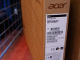two boxes of acer products sit on a shelf in front of a cage