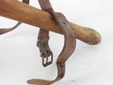 a wooden baseball bat with a leather strap attached to it