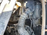 a car engine with a hose attached to it ' s hood