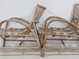 pair of bamboo lounge chairs with arms and legs in the shape of a reclining chair