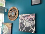 a glass table in front of a blue wall with pictures on it