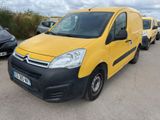 yellow citrole van parked in a parking lot next to other cars