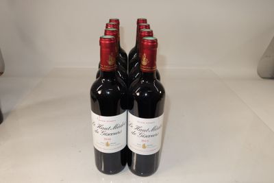 three bottles of red wine sitting on a table