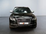 the front end of a black audi parked in a room