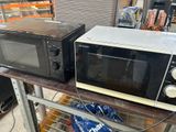 two microwaves sitting on a shelf in a store