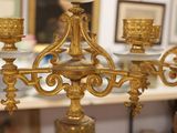 a gold chandelier with blue and white vases on it