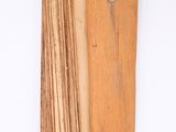 a piece of wood that has been cut and is hanging on the wall
