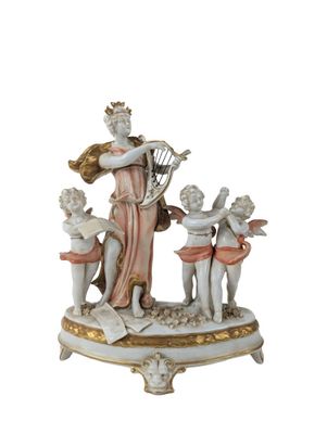 a figurine of a woman holding a harp and three cherensils