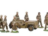 a lot of figurines of military men standing in front of a truck
